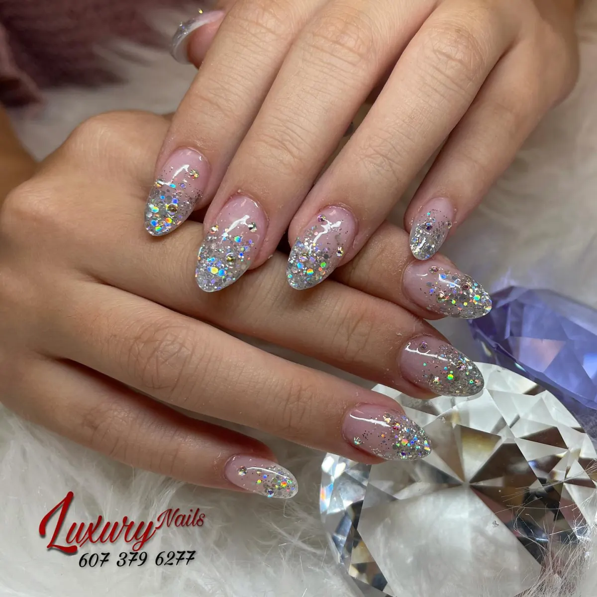 Silver glitter manicure with clear accent nails
