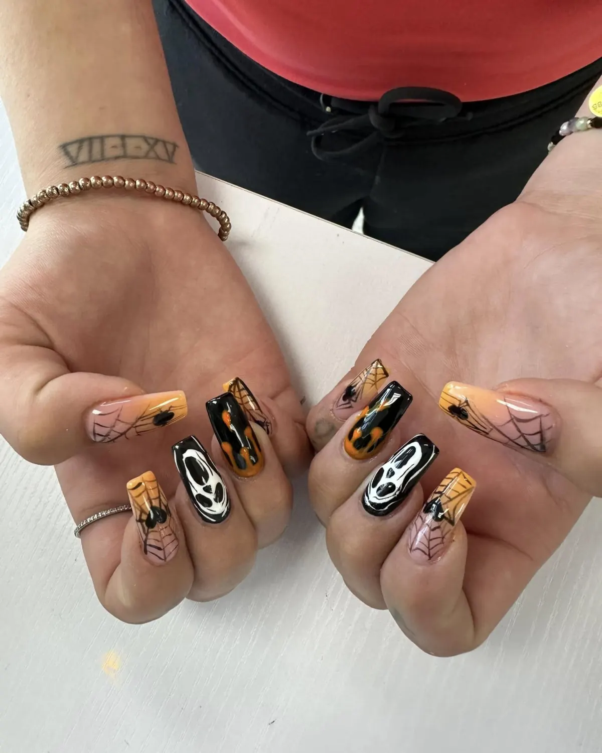 Gold and black seasonal nail art on both hands